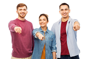 Image showing group of smiling friends pointing at you over