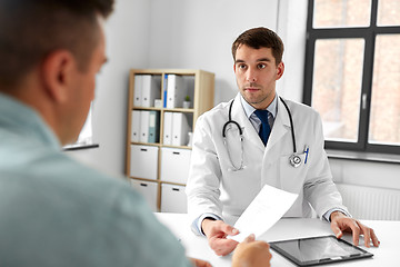 Image showing doctor giving prescription to patient at hospital