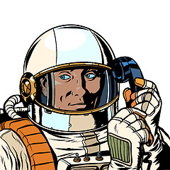 Image showing serious astronaut talking on a retro phone. isolate on white background