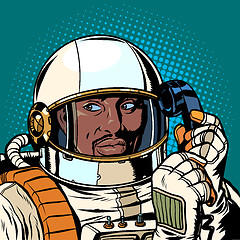 Image showing serious african astronaut talking on a retro phone