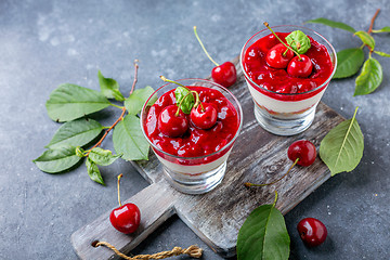 Image showing Sweet cherry cheesecake in glasses.