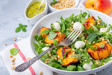 Image showing Salad with grilled nectarines, arugula and pesto.