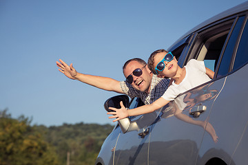 Image showing Happy father and son sitting in the car at the day time.