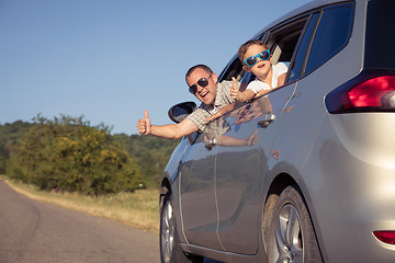 Image showing Happy father and son sitting in the car at the day time.