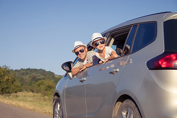 Image showing Happy father and son sitting in the car at the day time.