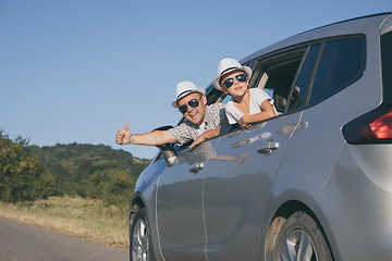 Image showing Happy father and son sitting in the car at the day time.