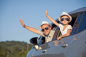 Image showing Happy father and son sitting in the car at the day time.