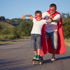 Image showing Father and son playing superhero at the day time.