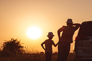 Image showing Father and son playing in the park at the sunset time.