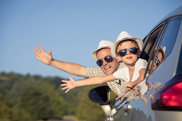 Image showing Happy father and son sitting in the car at the day time.