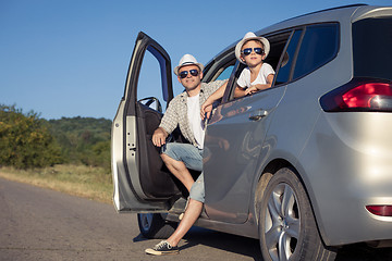 Image showing Happy father and son sitting in the car at the day time.