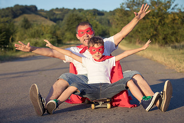 Image showing Father and son playing superhero at the day time.