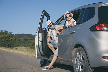 Image showing Happy father and son sitting in the car at the day time.