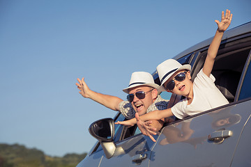 Image showing Happy father and son sitting in the car at the day time.