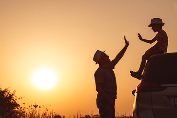 Image showing Father and son playing in the park at the sunset time.