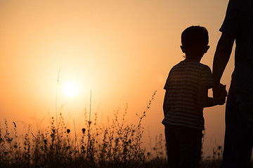 Image showing Father and son playing in the park at the sunset time.