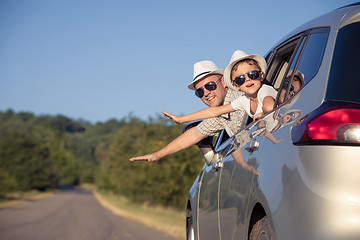 Image showing Happy father and son sitting in the car at the day time.