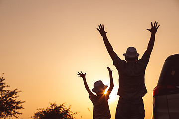 Image showing Father and son playing in the park at the sunset time.