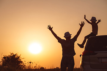 Image showing Father and son playing in the park at the sunset time.