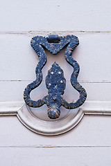 Image showing Italian door knocker on wooden painted white door.