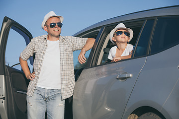 Image showing Happy father and son sitting in the car at the day time.