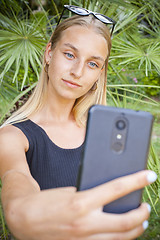 Image showing Young woman taking selfie on the ancient town park against summe