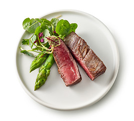 Image showing Plate of beef wagyu steak meat with herbs and asparagus