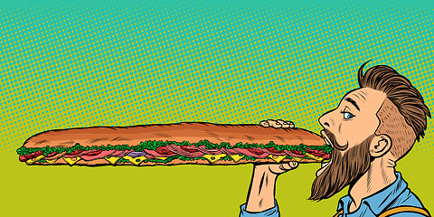 Image showing man eats a long sandwich