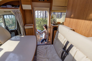 Image showing Woman in the interior of a camper RV motorhome with a cup of cof