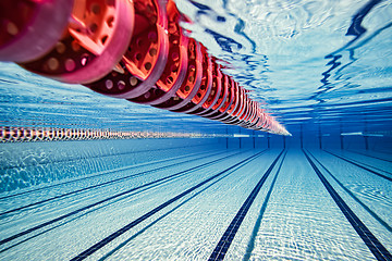 Image showing Olympic Swimming pool under water background.