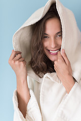 Image showing woman in a white coat with hood isolated on blue background