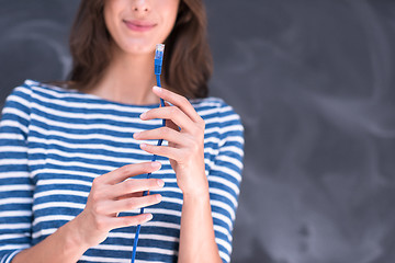 Image showing woman holding a internet cable in front of chalk drawing board