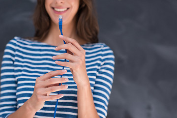 Image showing woman holding a internet cable in front of chalk drawing board