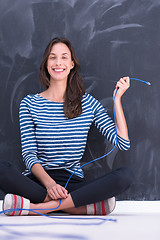 Image showing woman holding a internet cable in front of chalk drawing board