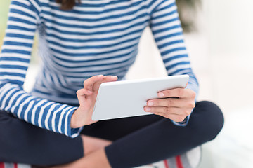 Image showing young women using tablet computer on the floor