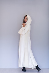 Image showing woman in a white coat with hood isolated on white background