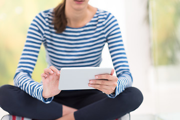 Image showing young women using tablet computer on the floor