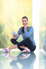 Image showing young women using tablet computer on the floor