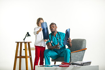 Image showing Young african male pediatrician explaining X-ray to child