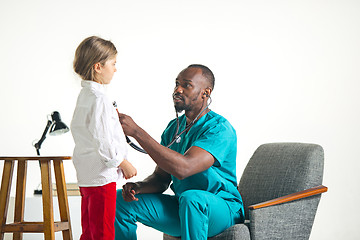 Image showing healthcare and medical concept - doctor with stethoscope listening to child chest in hospital