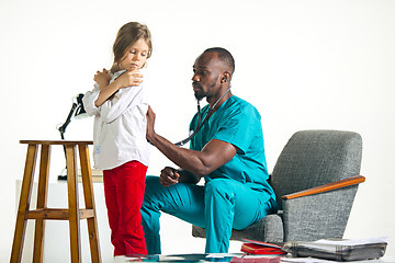 Image showing healthcare and medical concept - doctor with stethoscope listening to child chest in hospital