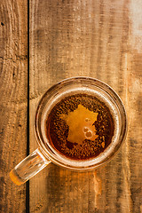 Image showing French beer concept, France silhouette on foam in beer glass on wooden table.