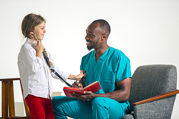 Image showing healthcare and medical concept - doctor and girl with stethoscope in hospital