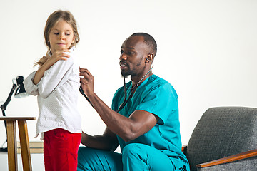 Image showing healthcare and medical concept - doctor with stethoscope listening to child chest in hospital