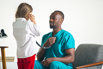 Image showing healthcare and medical concept - doctor with stethoscope listening to child chest in hospital