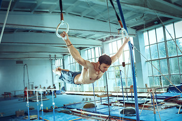 Image showing The sportsman during difficult exercise, sports gymnastics