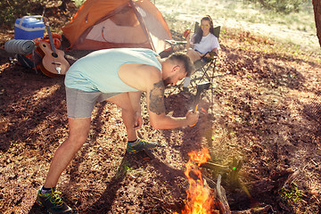 Image showing Party, camping of men and women group at forest. They relaxing