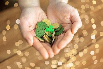 Image showing hands with golden coins and shamrock leaf