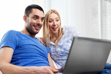 Image showing happy couple with laptop computer at home