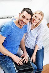 Image showing happy couple with laptop computer at home